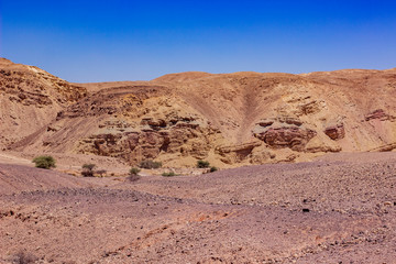desert landscape dry wasteland scenic environment view valley and sand stone rocky mountain ridge horizon background vivid blue sky copy space for text here