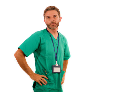 Attractive And Successful Physician Man Posing Confident For Hospital Staff Corporate Portrait  In Green Medical Uniform Isolated On White Background In Health Care