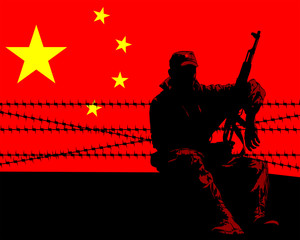 Soldier in protective uniform with machine gun on background of Chinese flag