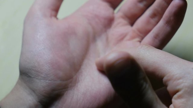 Palmistry. A man shows an individual line drawing on the skin of the palm