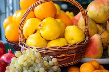 Street side shop selling fruits pomegranates, oranges, grapes and others.