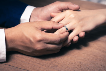 Obraz na płótnie Canvas Groom wearing the wedding ring to Bride finger.