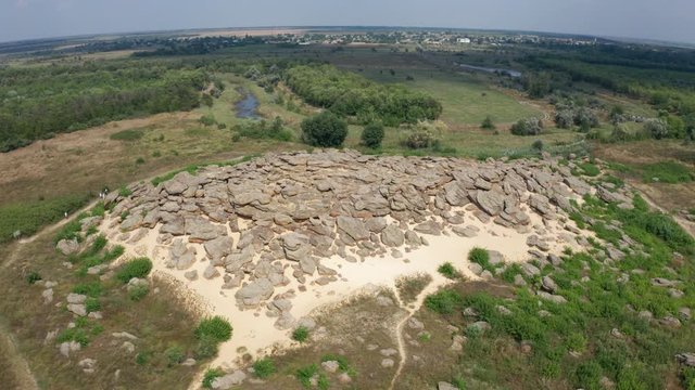 Drone shot of ancient archaeological site called Kamyana Mohyla or literally stone tomb, encompassing group of isolated blocks of sandstones, up to twelve meters in height, Melitopol region, Ukraine