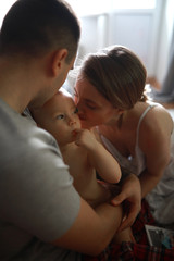 Fototapeta premium Parents play with their little daughter.