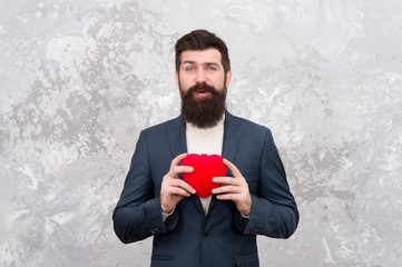 Brought present. Bearded man hold red heart. Valentine present. Hipster give present abstract...
