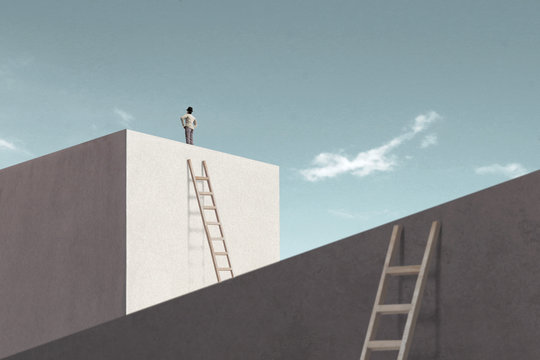 man rising stairs to reach the top of minimalist structure