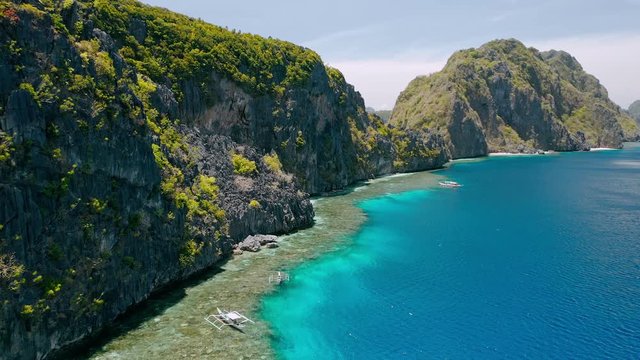 Matinloc island, El Nido, Palawan, Philippines. Aerial view of picturesque sea coast, crystal clear water, sharp cliffs and coral reefs