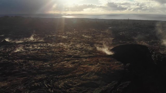 steaming lava field and fissure eight aerial shot in early morning sunlight