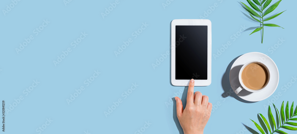 Poster person using a tablet computer from above