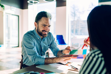 Man showing diagram to colleague in workplace