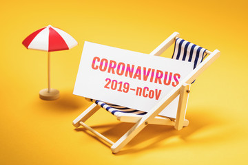 Sun umbrella, deck chair and a sheet of paper with the inscription. Concept on beach closure due to dangerous outbreak of coronavirus 2019-nCoV