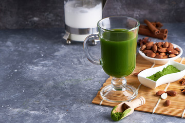 Green tea Matcha in glass on gray stone background