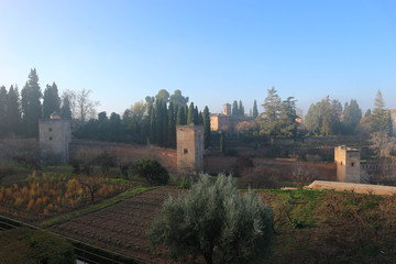 Fototapeta na wymiar View to Alhambra in the morning haze from Generalife gardens, Granada, Spain