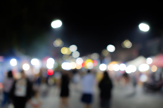 Blurred image of people in day market festival in city park background