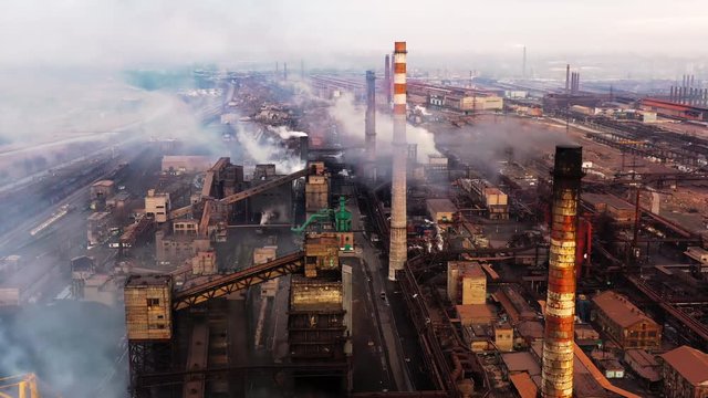Aerial. GLOBAL WARMING. View of high chimney pipes with grey smoke. Pipes Pollute Industry Atmosphere With Smoke Ecology pollution, Industrial factory pollutes, smoke stacks exhaust pipes