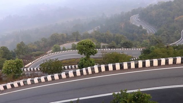 Patratu valley a clean n clear zig zag road in S or Z shape with lush greenery and sceneric views of hills across the way.