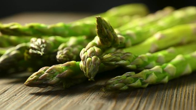 green asparagus lies on a wooden table