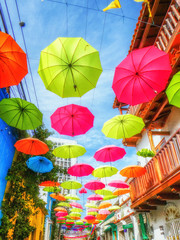 Street with umbrellas in Getsemani neighborhood in Cartagena de Indias, Colombia - obrazy, fototapety, plakaty