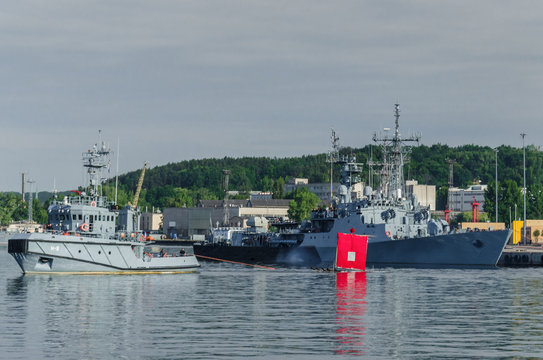 GDYNIA, POMERANIA REGION / POLAND - 2018: The Polish corvette ORP Kaszub and tugboat with a shooting traget flows out to sea
