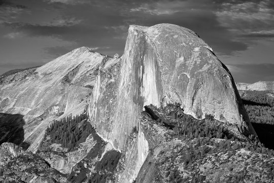 Black and white picture of Half Dome, famous granite dome of Yosemite Valley, California, USA.