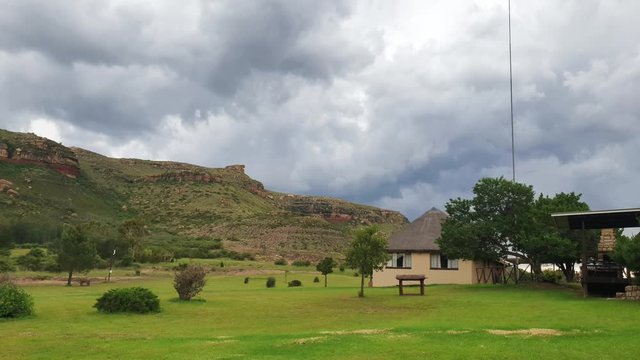 Moluti sandstone cliffs at the border of Lesotho in South Africa at the Camelroc travel guest farm, stunning cloud time lapse, most amazing mountains and green scenery landscapes
