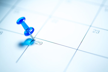 Blue push pin on calendar 29th leap year day of the month