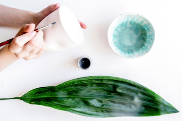 painted ceramic cup on white background top view