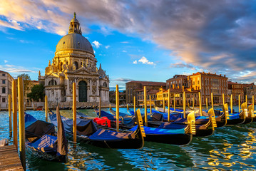 Sunrise view of Canal Grande with Venice gondola and Basilica di Santa Maria della Salute in...