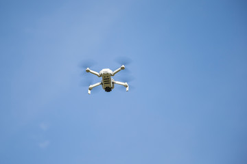 Drone flying in the blue sky.