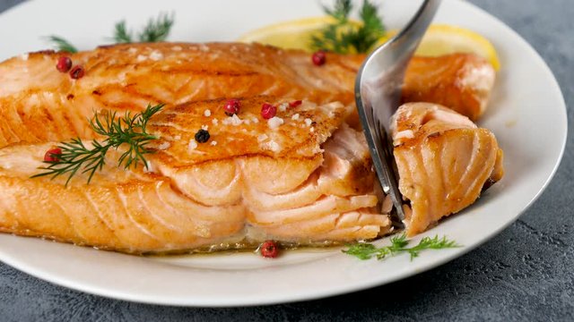 cooked salmon fish with lemon and herbs