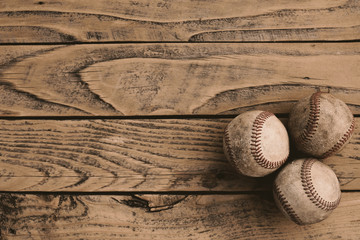 Grunge baseball background with old balls on vintage wood backdrop.