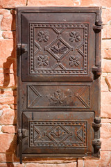 Wrought iron door of the stove with a national Ukrainian ornament. Iron door of the stove. Two old furnace doors. Ancient stove. Cast iron door for furnaces. Iron door ornament.
