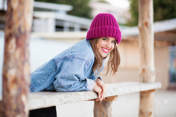 Young beautiful woman in denim jacket and knit hat