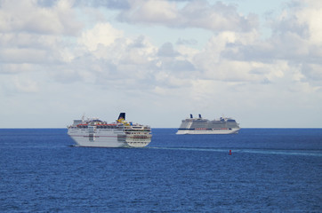 Celebrity Cruises and Carnival Cruise Line cruiseships or cruise ship vessels sailing towards...