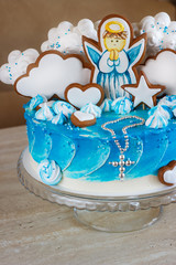 blue baptism cake with an angel on a gingerbread