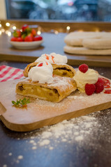Vertical view of ready to eat apple cake with cream - Stock image