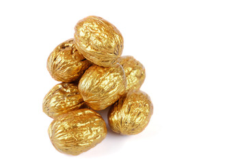 Golden walnuts on a white background