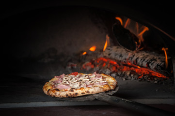 Pizza baking in traditional stone oven
