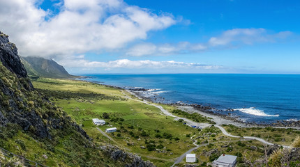 Fototapeta na wymiar Green coastline fields with blue ocean