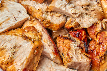 baked meat cut into pieces close up photo