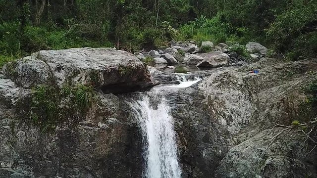 Creek Falls in Tropical Rainforest. Slowmotion Aerial View of Natural Waterfall in Puerto Rico