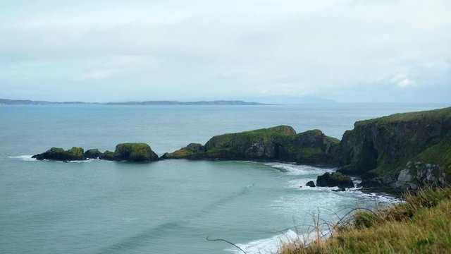 Northern Ireland green island coastal countryside landscape & ocean seascape view from high grassy hill.