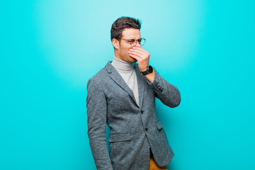 young arabian man feeling disgusted, holding nose to avoid smelling a foul and unpleasant stench...