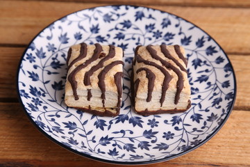small chocolate cakes in color background