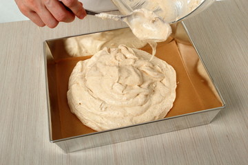 Spoon mixture into tin and smooth top. Making Chocolate Hazelnut Meringue Cake.
