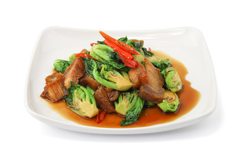 Stir fried Chinese broccoli with Crispy Pork isolated on white background with clipping path, Stir Fried Crispy Pork with Kale, Thai food.