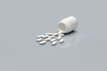 Side view of bottle and scattered pills on gray background. Space for text