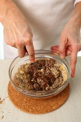 Making filling, fold nut mixture into melted chocolate. Making Chocolate Hazelnut Meringue Cake.