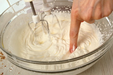Making filling. Whipping cream. Making Chocolate Hazelnut Meringue Cake.