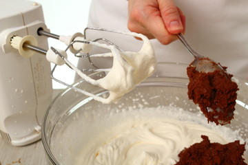 Making filling. Add chocolate mixture into whipped cream until just combined. Making Chocolate Hazelnut Meringue Cake.